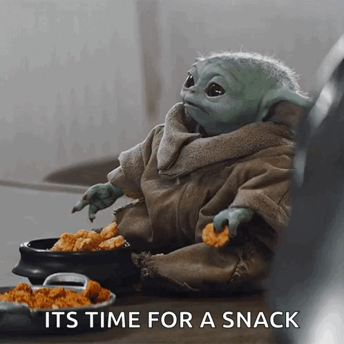 A Baby Yoda Is Sitting At A Table Eating Chicken Nuggets And A Bowl Of Chicken Nuggets . GIF