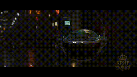 A Baby Yoda Is Sitting In The Back Seat Of A Car At Night . GIF