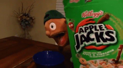 a bag of apple jacks cereal sits on a table next to a blue bowl