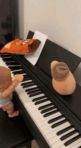 A Bag Of Cheetos Chips Sits On A Piano GIF