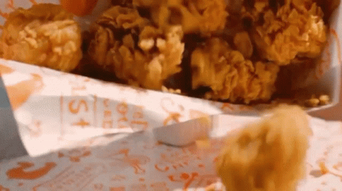 A Bag Of Fried Chicken With A Sticker That Says ' Chicken Nuggets ' On It GIF