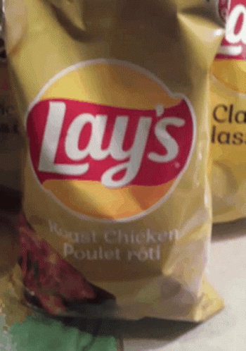 A Bag Of Lay 'S Roast Chicken Chips Sits On A Table GIF