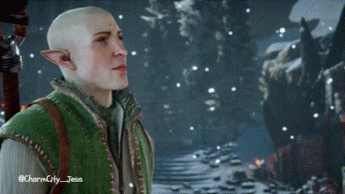 A Bald Elf In A Green Vest Is Standing In A Snowy Forest . GIF