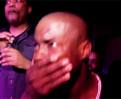 A Bald Man Covering His Mouth With His Hand GIF