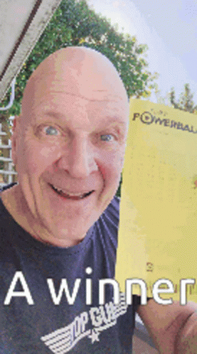A Bald Man In A Black Shirt Is Holding Up A Powerball Ticket GIF