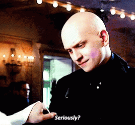 A Bald Man In A Black Suit Is Holding A Woman 'S Hand And Asking Her To Seriously GIF