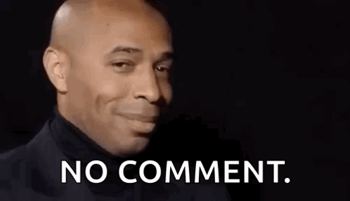 A Bald Man In A Black Turtleneck Is Making A Funny Face And Saying No Comment . GIF
