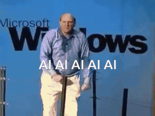 a bald man in a blue shirt is clapping his hands and the words ai ai ai ai are visible