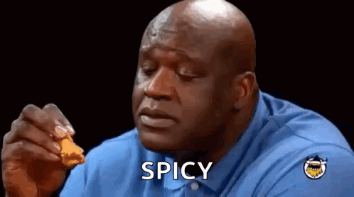 A Bald Man In A Blue Shirt Is Eating Chicken Nuggets And Says Spicy . GIF