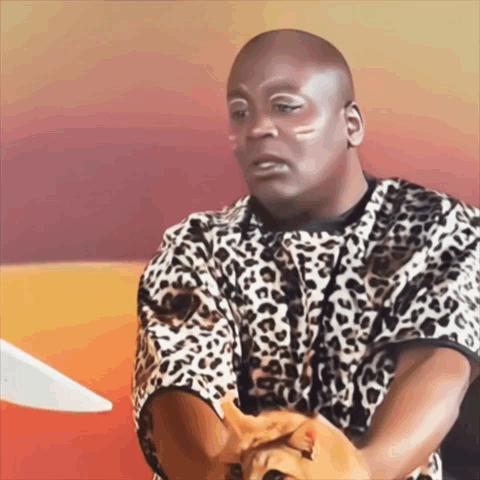 A Bald Man In A Leopard Print Shirt Holds A Cat GIF