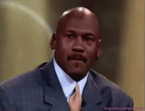 A Bald Man In A Suit And Tie Is Being Touched By A Hand GIF