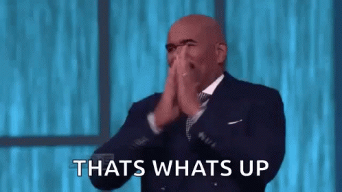 A Bald Man In A Suit And Tie Is Clapping His Hands And Saying `` That 'S What 'S Up '' . GIF
