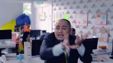 A Bald Man In A Suit And Tie Is Making A Funny Face GIF