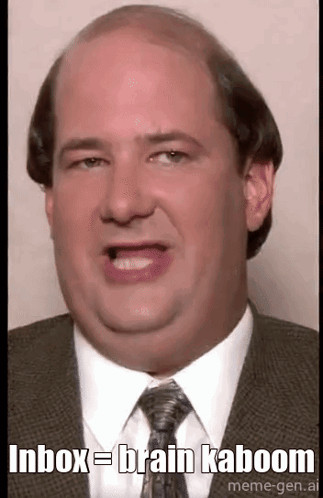 A Bald Man In A Suit And Tie Is Making A Funny Face And Saying `` Inbox = Brain Kaboom '' . GIF