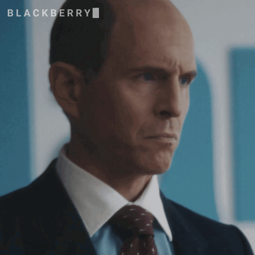 A Bald Man In A Suit And Tie With The Word Blackberry On The Bottom GIF
