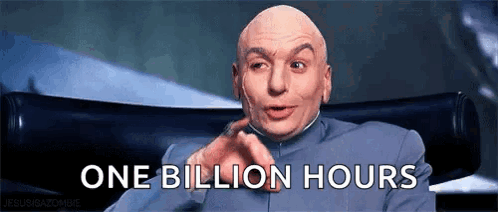 A Bald Man In A Suit Is Sitting In A Chair And Says One Billion Hours GIF