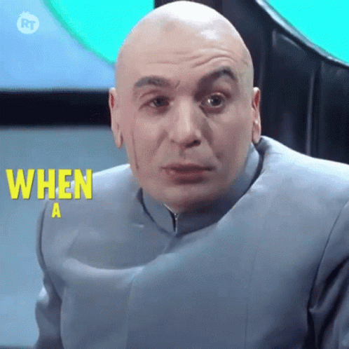 A Bald Man In A Suit Says " When A " In Yellow Letters GIF