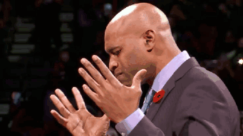 A Bald Man In A Suit With A Poppy On His Lapel Is Clapping His Hands GIF
