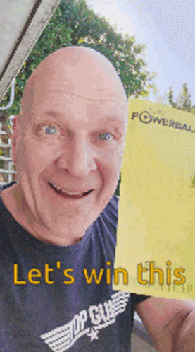A Bald Man In A Top Gun Shirt Is Holding Up A Yellow Powerball Ticket GIF