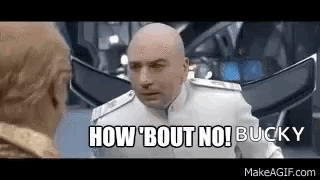 A Bald Man In A White Suit Is Talking To Another Bald Man In A Room . GIF