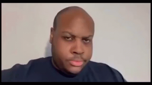 A Bald Man Is Blowing A Pink Bubble With His Mouth Open . GIF