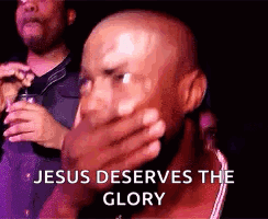 A Bald Man Is Covering His Mouth With His Hand And The Words `` Jesus Deserves The Glory '' Are Behind Him . GIF