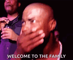 A Bald Man Is Covering His Mouth With His Hand And The Words `` Welcome To The Family '' . GIF