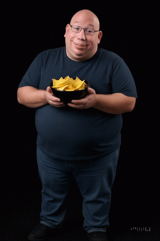 A Bald Man Is Pouring Yellow Liquid Into A Bowl Of Food GIF