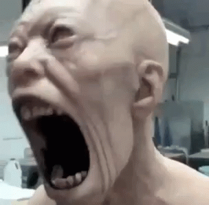 A Bald Man Is Screaming With His Mouth Open . GIF