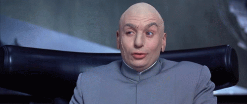 A Bald Man Is Sitting In A Chair With His Mouth Open GIF