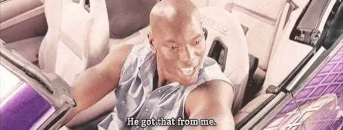 A Bald Man Is Sitting In The Back Seat Of A Car . GIF