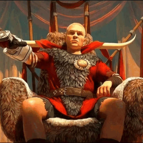 A Bald Man Is Sitting On A Throne Wearing A Red Fur Coat GIF