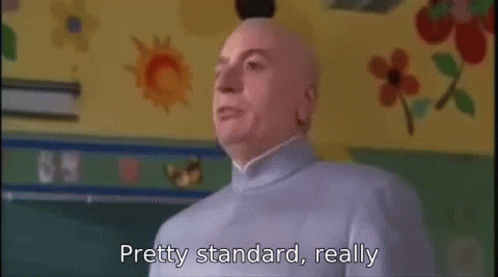 A Bald Man Is Standing In Front Of A Chalkboard In A Classroom And Says `` Pretty Standard , Really '' . GIF