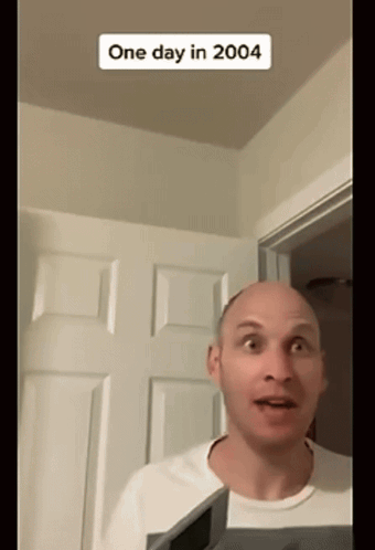 Bald Man Standing In Front Of Door With 2004 Sticker GIF