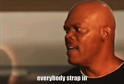 A Bald Man Says " Everybody Strap In " In A Close Up GIF