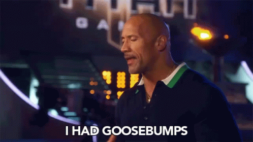 A Bald Man Says I Had Goosebumps In Front Of A Sign That Says Gam GIF