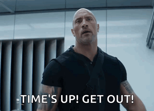 A Bald Man Says Time 'S Up Get Out In A Movie Scene GIF
