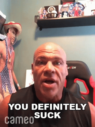 A Bald Man Says " You Definitely Suck " In Front Of A Picture Of A Man In A Bikini GIF