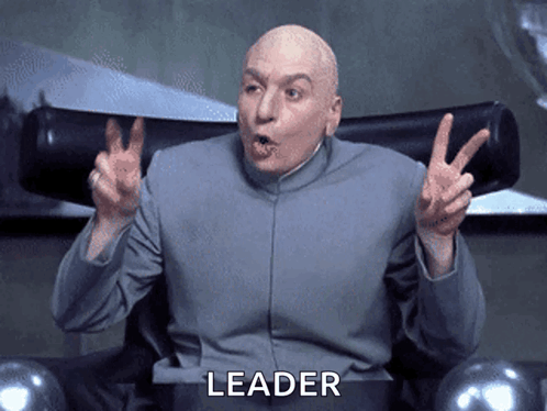 A Bald Man Sitting In A Chair With The Word Leader Written On The Bottom GIF