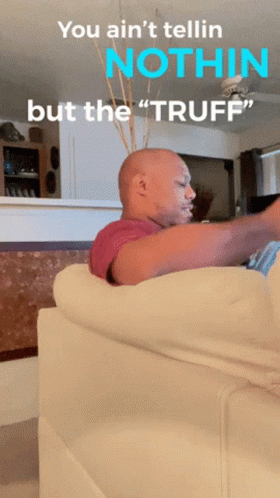 A Bald Man Sitting On A Couch With The Words " You Ain 'T Tellin Nothin But The Tuff " GIF