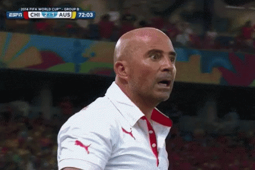 A Bald Man Stands In Front Of A Screen That Says Fifa World Cup Group B On It GIF