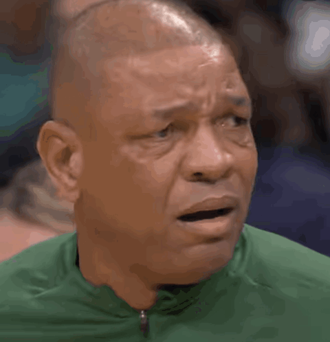 A Bald Man Wearing A Green Shirt Is Making A Surprised Face GIF