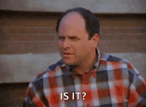 A Bald Man Wearing A Plaid Shirt Is Asking Is It . GIF