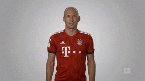a bald man wearing a red adidas shirt with the letter t on it