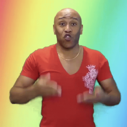 A Bald Man Wearing A Red Shirt Is Making A Face GIF