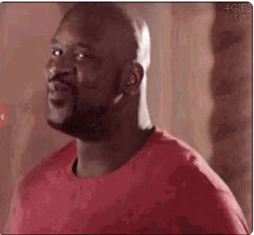 A Bald Man Wearing A Red Shirt Is Making A Funny Face . GIF