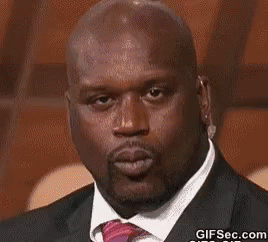 A Bald Man Wearing A Suit And Tie Is Blowing A Kiss . GIF