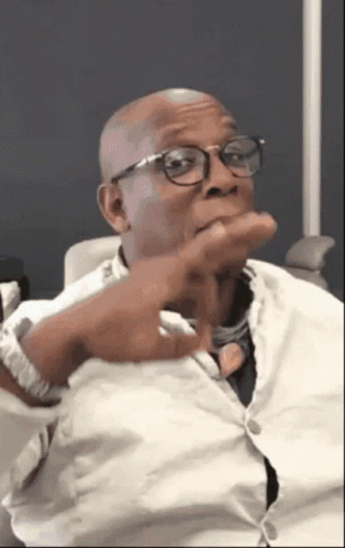 A Bald Man Wearing Glasses And A White Shirt GIF