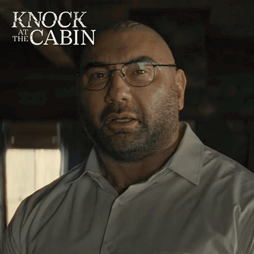 A Bald Man Wearing Glasses And A White Shirt With The Words Knock At The Cabin On The Bottom GIF
