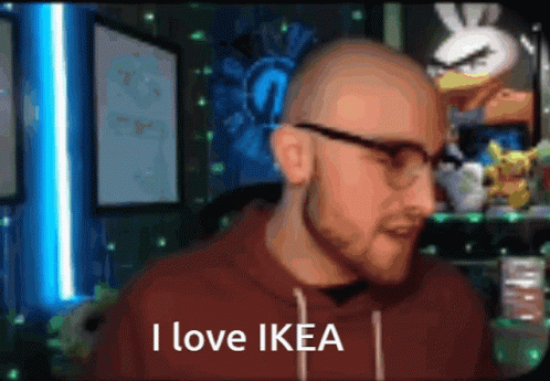a bald man wearing glasses says " i love ikea "